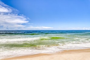 A beach with clear blue sky and ocean waves. - Gorgeous & sun-kissed retreat with pool, gym, W/D, & incredible balcony views (Orange Beach)
