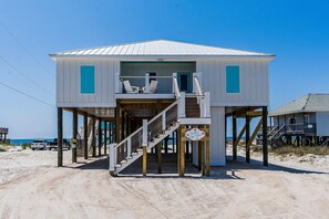 A beach house with a balcony, wooden stairs, and a sign indicating a beach view. - 2 dog-friendly beach houses right on the sand w/private heated pool & elevator (Dauphin Island)