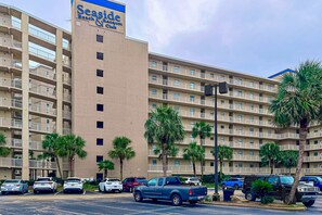 A multi-story hotel with a sign reading 'Seaside Beach & Yacht Club.' - 6th-floor remodeled condo w/ Gulf views, beach access, pools, tennis, & BBQ area (Orange Beach)