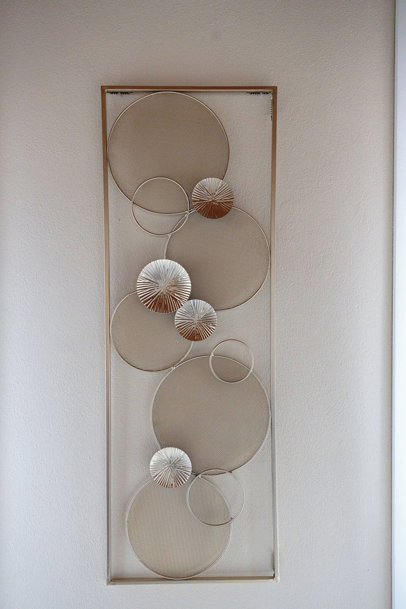 A wall with a series of circular patterns.