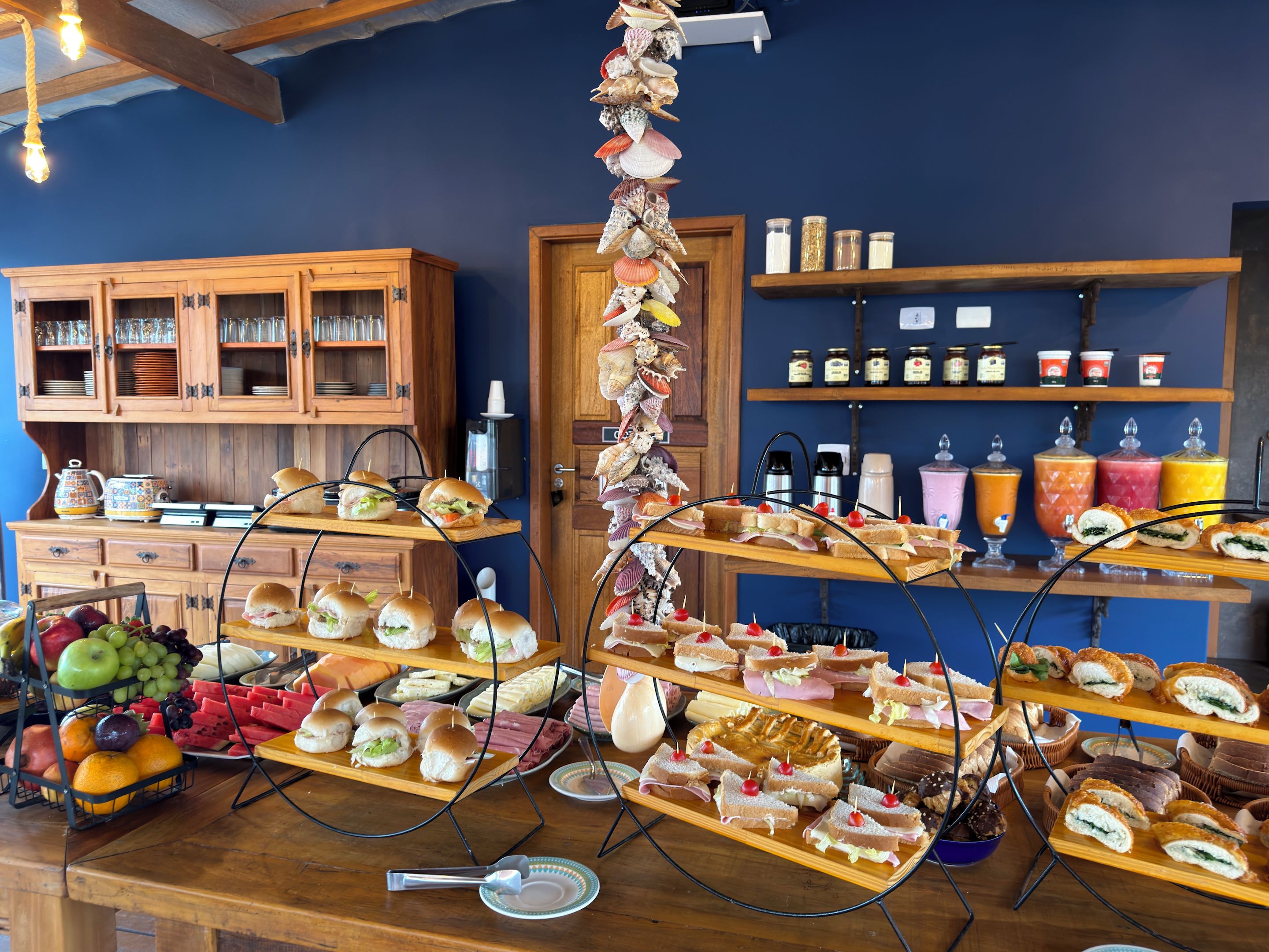 A buffet setup with various food items and a selection of beverages.
