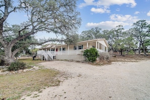 A two-story house with a porch and a covered front porch area.