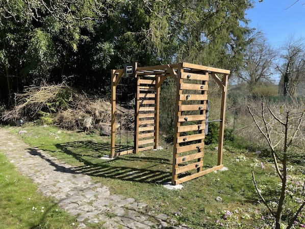 A wooden pergola structure in a garden setting.