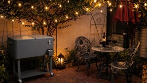 A patio with a grill, chairs, a table, and string lights. - Elegant Designer Suite: Serene Garden View & Private Entry (Escondido)