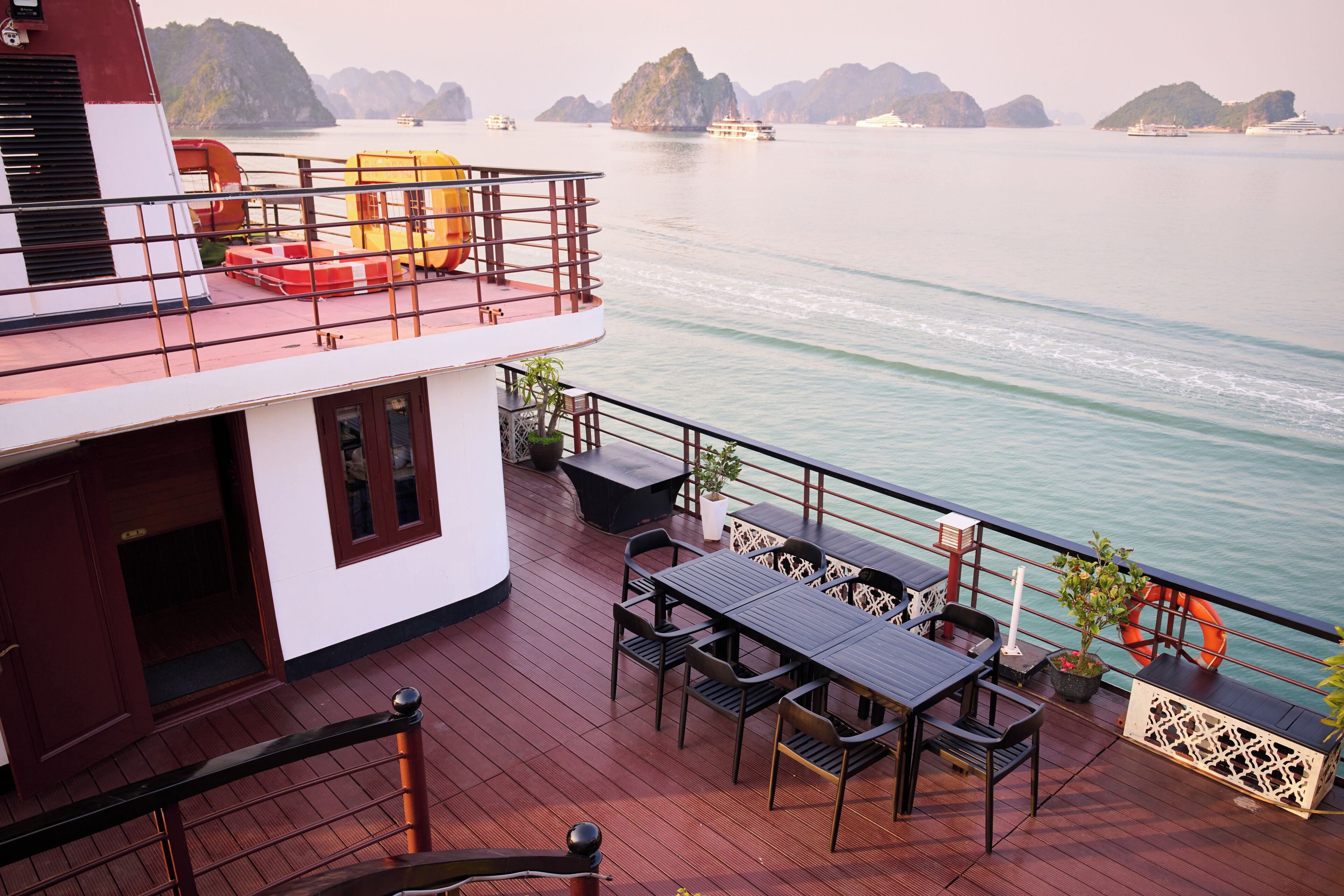 A deck with outdoor seating and a view of the water.