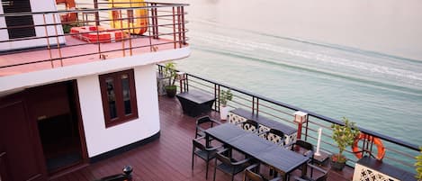 A deck with outdoor seating and a view of the water.