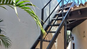 A metal staircase leading to a building with a white exterior wall and a tiled roof. - Detached Terrace Cottage for Adults Only (Icod de los Vinos)