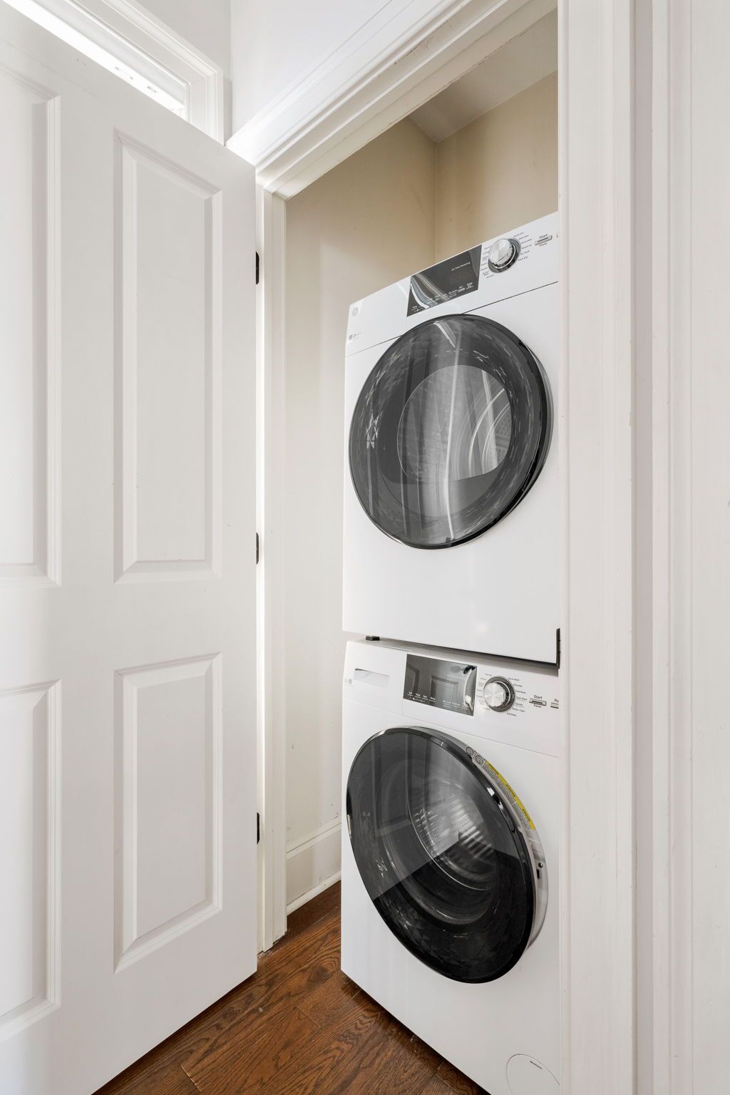 A laundry room with two stacked front-loading washing machines.