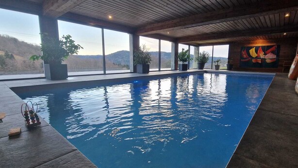 Ein großer, überdachter Pool mit freiem Blick auf die umliegende Landschaft.