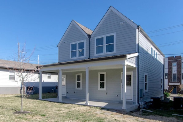 A two-story house with a covered porch and a garage.
