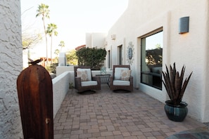 A patio with two wicker chairs, a small table, and a potted plant. - The Bradford - Southwest Luxury w/ Pool + Mountain Views in Sunny Fountain Hills (Fountain Hills)