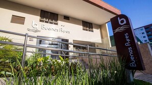 A hotel entrance with a sign reading "Buenos Ayres" and a logo with a wave and the letter 'b'. - Buenos Ayres #509 - Apt With Balcony by Carpediem (João Pessoa)