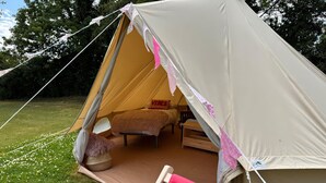 A tent with a bed, pillows, and a blanket. - Dovedale (Ashbourne)