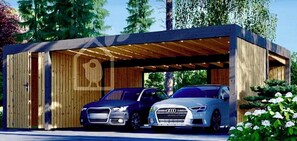 Eine moderne Autogarage mit zwei darin stehenden Autos, mit Holzfassade und Metallbedachung.