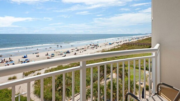 A balcony with a view of a beach. - 1 bdrm oceanfront resort (North Myrtle Beach)
