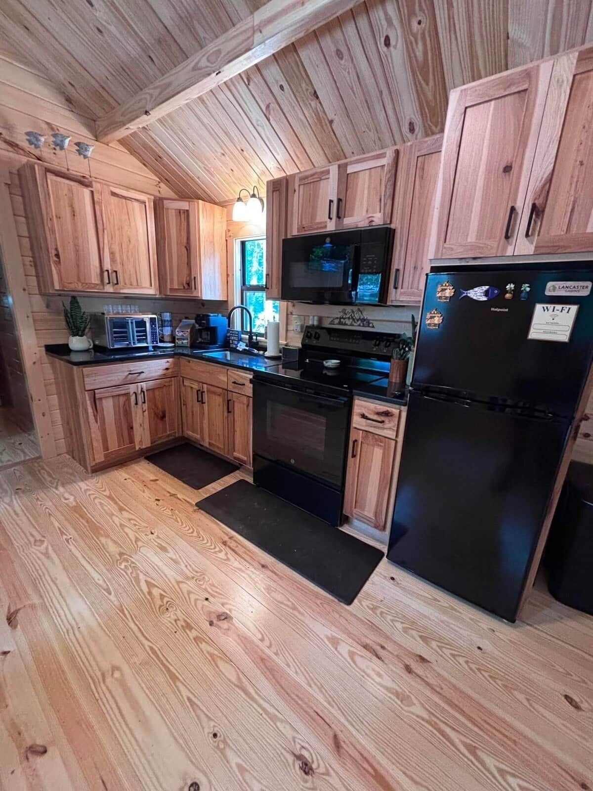 Coffee/tea maker, fridge, paper towels, dining table