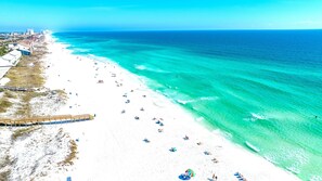 A beach with a wooden boardwalk, white sandy beach, and clear turquoise waters. - Windsong! New! Sleeps 19! Beach! (Destin)