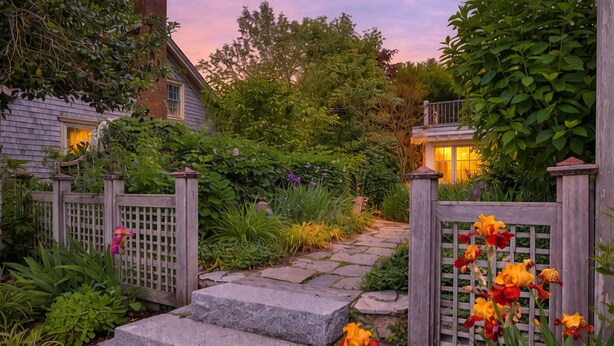 A garden pathway leading to a house with a wooden fence and steps. - Harbor Views, Parking, Roof Deck, Beach - West End (Provincetown)