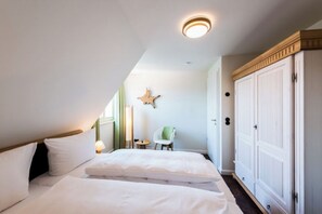 Ein Schlafzimmer mit Bett, Nachttisch, Stuhl und Kleiderschrank.