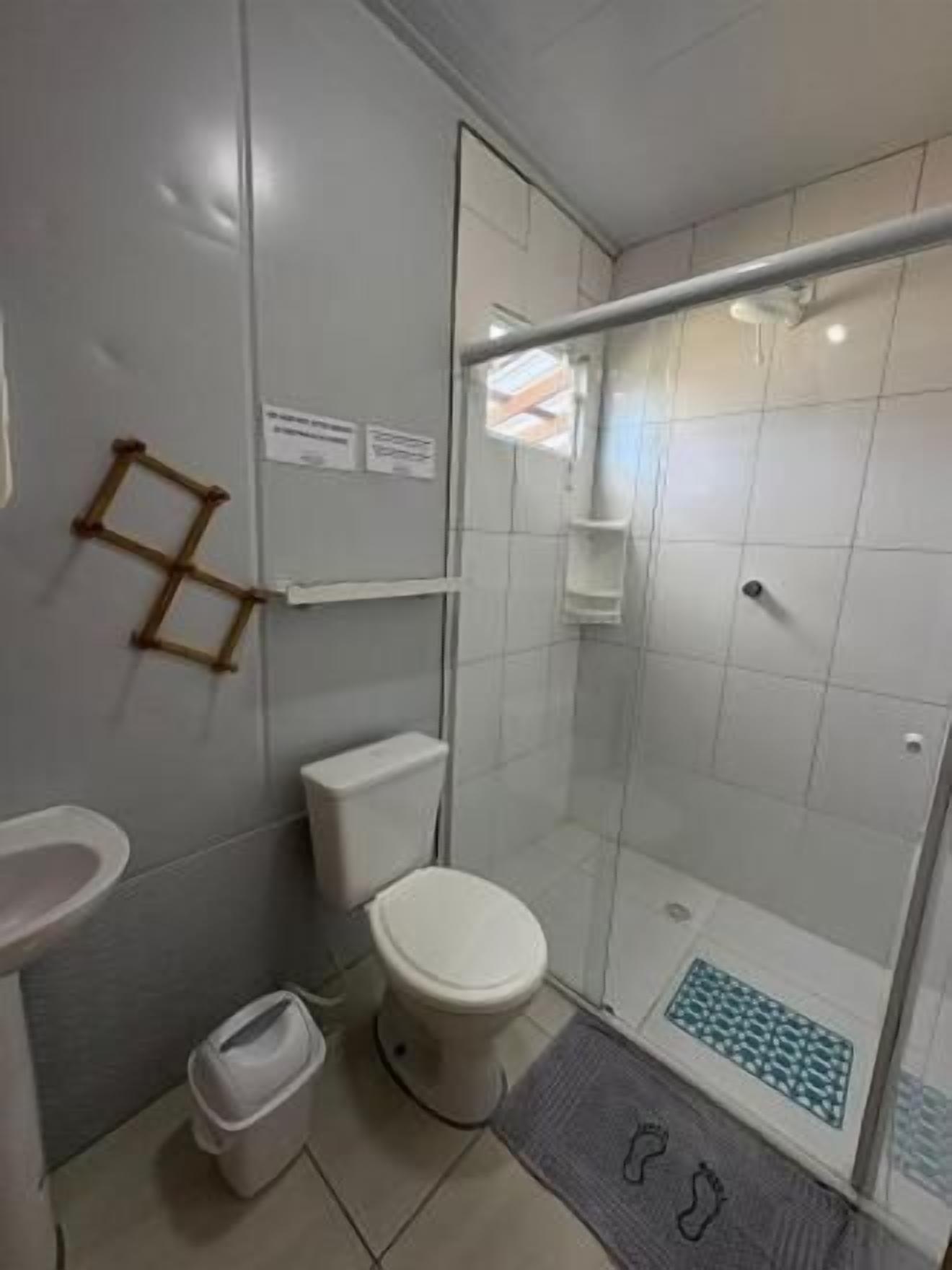 Een badkamer met toilet, wastafel en douche.
