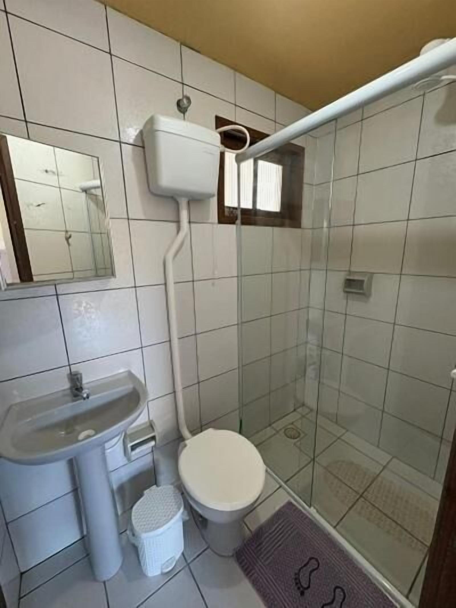 A bathroom with a sink, toilet, and shower.