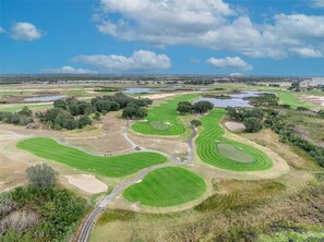 A golf course with multiple greens, sand bunkers, and a water hazard. - Maidstone Magic: Hot Tub & Pool, Theater, by Parks (Four Corners)