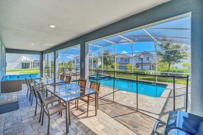 A covered outdoor area with a pool, glass tables, and chairs. - Maidstone Magic: Hot Tub & Pool, Theater, by Parks (Four Corners)