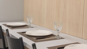 A dining table with plates, cutlery, and a glass. - Unity #222 a Few Steps From the Beach by Carpediem (João Pessoa)