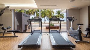 A gym with treadmills, a stationary bike, and a bench. - Unity #222 a Few Steps From the Beach by Carpediem (João Pessoa)
