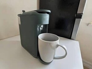 A coffee maker and a white mug on a white countertop. - Cozy Studio – Free Bikes – 1 Mi to Beach (Bonita Springs)