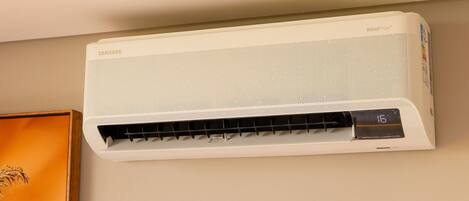 A white wall-mounted air conditioner with a digital display showing 16 degrees Celsius.