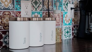 Three white containers with lids labeled "Tea," "Sugar," and "Coffee" on a tiled floor. - Private Luxury Loft in Down town/ Jalatlaco with A/C (Oaxaca de Juárez)