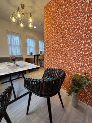 A modern dining area with a marble table, black chairs, a patterned wall, and a ceiling light fixture. - Private house in Shinjuku Ward 73m 13 minutes b / Shinjuku Ward Tokyo (Shinjuku Ward)