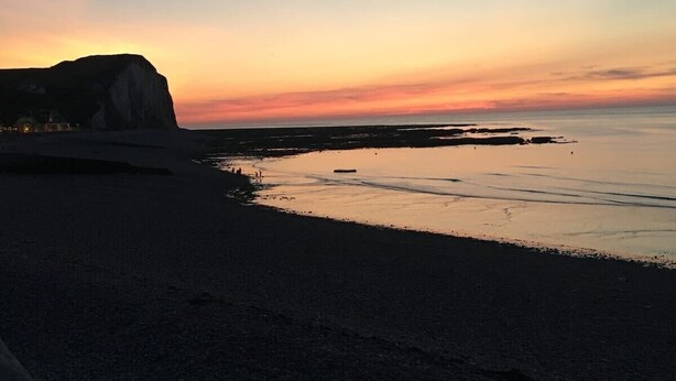 A beach with a cliff and calm waters during sunset. - Roirand | Romantic Beach on Foot (Veules-les-Roses)