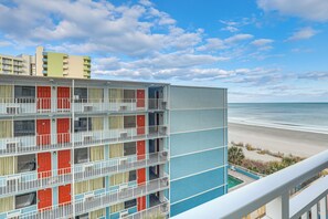 A multi-story hotel with balconies, a pool, and a beach view. - Ocean-View Balcony! Couples Escape in Myrtle Beach (Myrtle Beach)