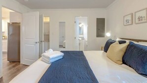Une chambre d’hôtel comprenant un lit, une salle de bain et un coin cuisine.