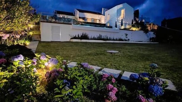 A modern house with a large front yard and a swimming pool. - Benilde Village House (Povoacao)