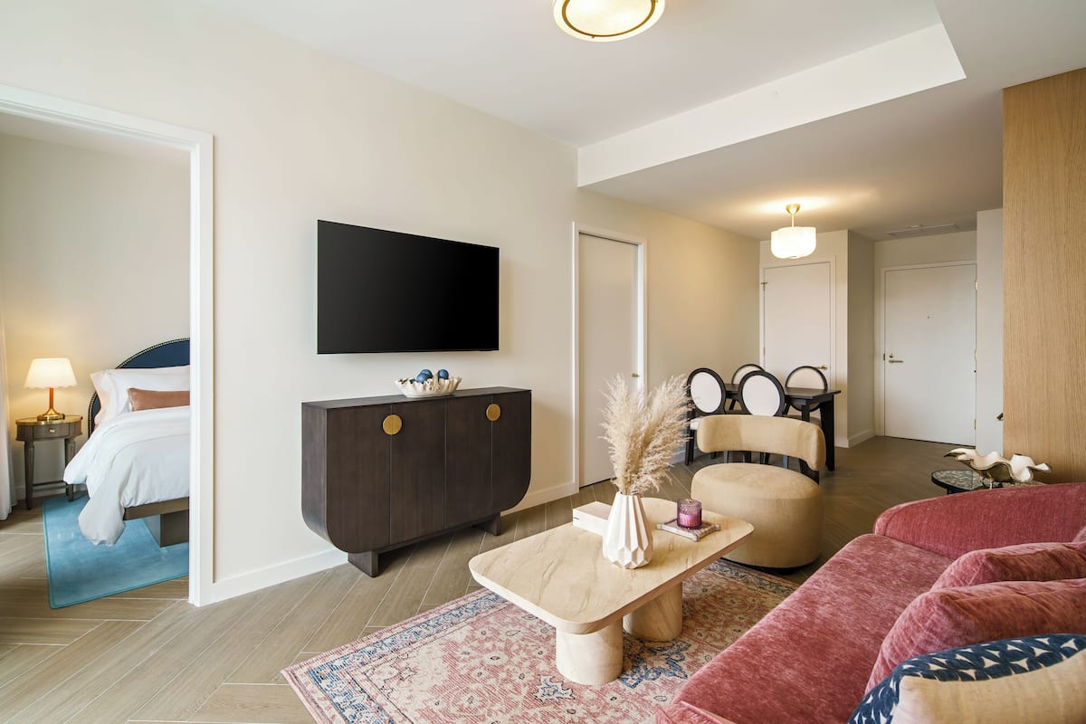 One Bedroom Queen Suite | Living area | 55-inch Smart TV with cable channels