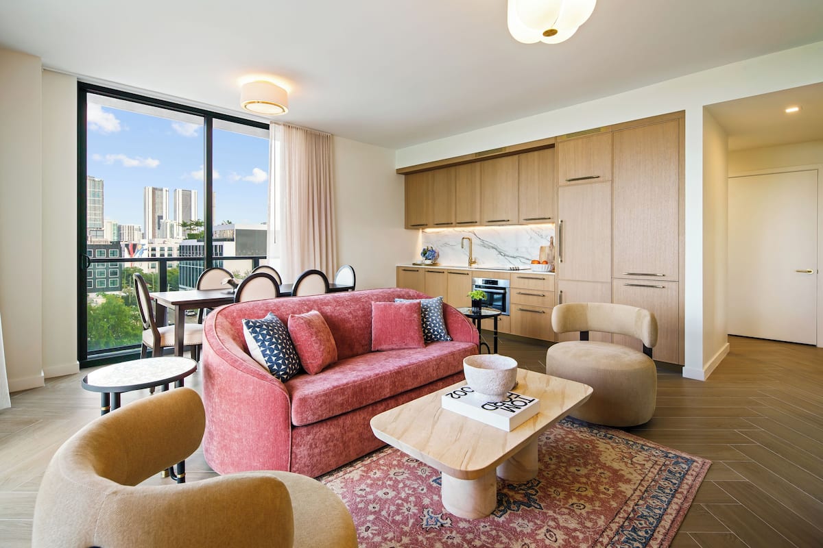 Deluxe Two Bedroom Corner Queen Suite | Living area | 55-inch Smart TV with cable channels