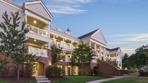 A multi-story building with a central courtyard, featuring balconies and a brick facade. - 2 bdrm near William and Mary (Williamsburg)