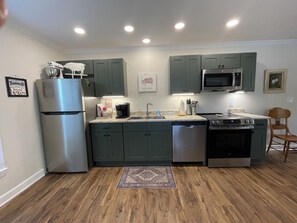 A modern kitchen with a refrigerator, microwave, stove, and dishwasher. - 2 Bedroom Duplex Vance Villa in UPTOWN Lexington! (Lexington)