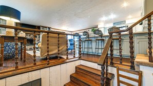 A wooden staircase with a handrail, a bar area with stools, and a sign labeled "LAKEHOUSE". - Steps to Shore: Group Getaway on Kentucky Lake! (Hardin)