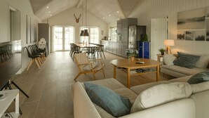 A spacious living area with a high ceiling, a dining area, and a kitchen. - Nice home in Grenaa with sauna (Grenaa)