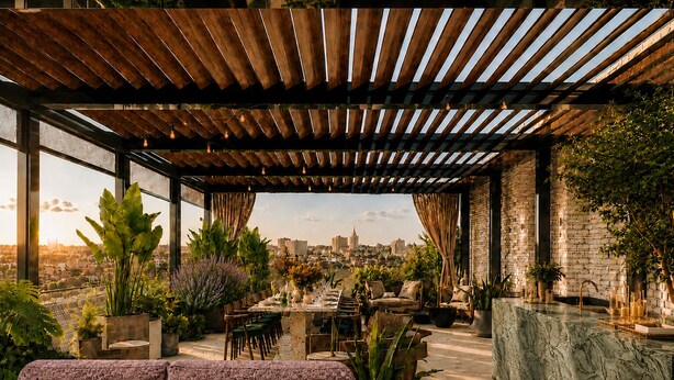 A rooftop terrace with a wooden pergola, seating, potted plants, and a view of a cityscape. - Sítio El Tropicano (San Antonio)