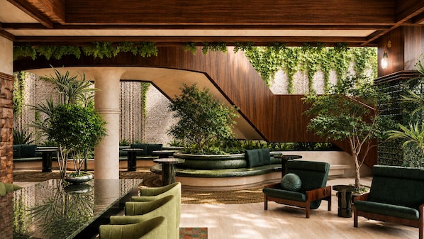A modern interior with a curved seating area, a staircase, and greenery. - Sítio El Tropicano (San Antonio)