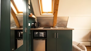 A compact kitchen with a built-in microwave, a coffee maker, and a sink. - Luxury Cabin with Hot Tub and Pergola in Yorkshire (Northallerton)