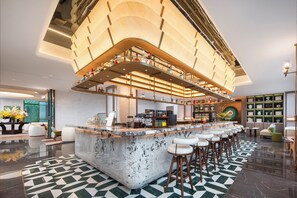 A modern bar area with a marble countertop, multiple stools, and a high ceiling with exposed beams. - Nantong Rudong By Ihg (Nantong)