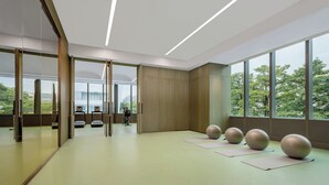 A modern room with large windows, exercise balls, and a yoga mat. - Xiamen Sm City By Ihg (Xiamen)