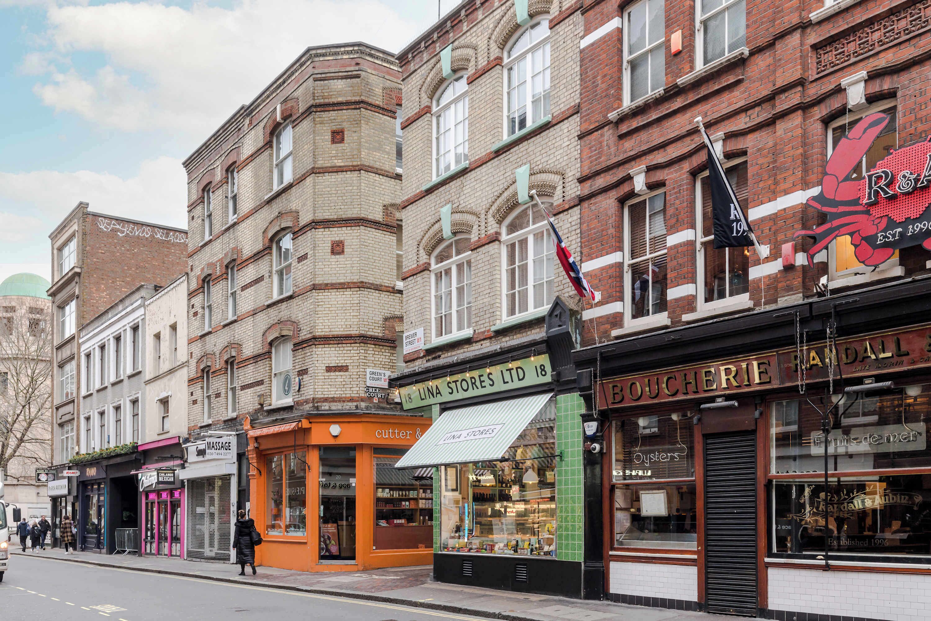 A street view with buildings, including a store named 'Lina Stores Ltd' and a shop with a sign 'Boucherie'.