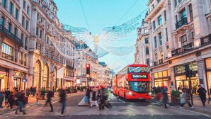 A double-decker bus on a city street with pedestrians and buildings. - The Lipstick Palace - Fitzrovia - by Frankie Says (London)
